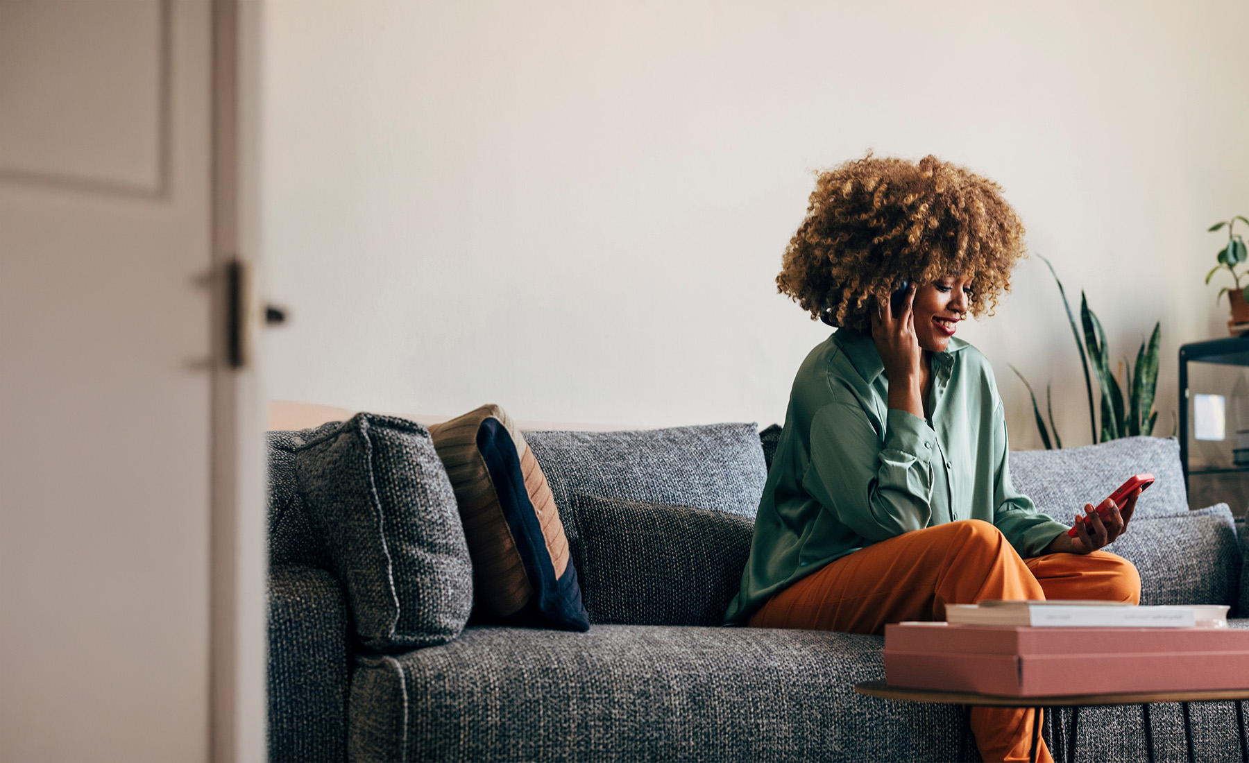 Woman on the sofa looks at her phone